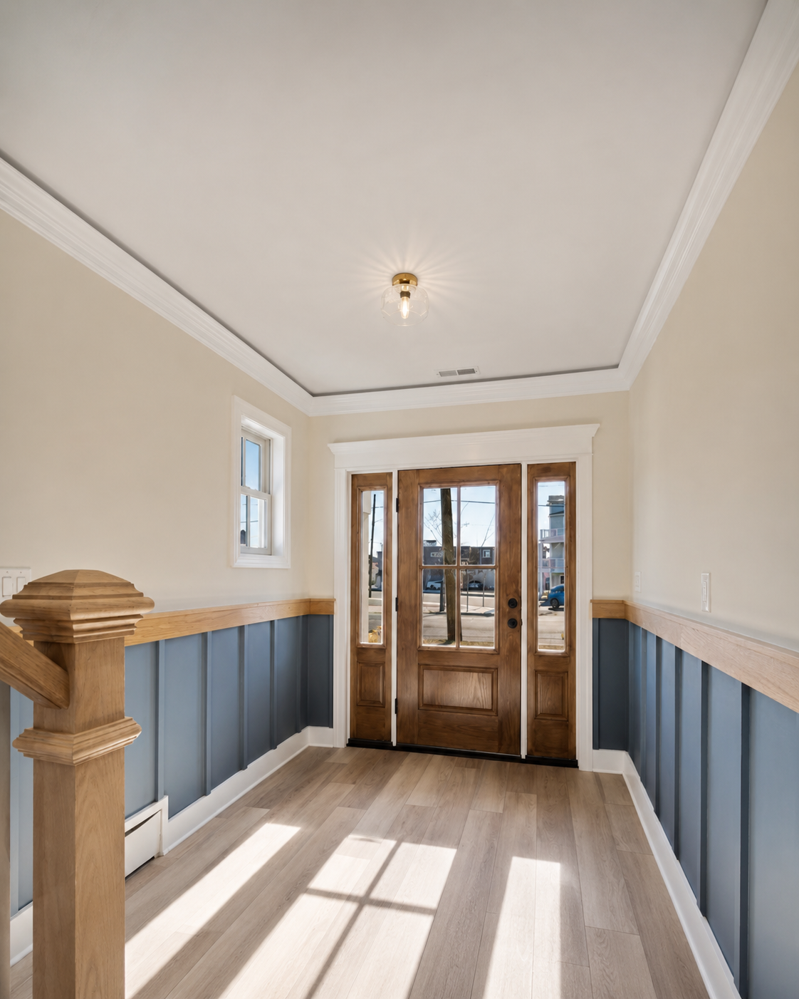 Completed custom foyer with paneling and entryway trim
